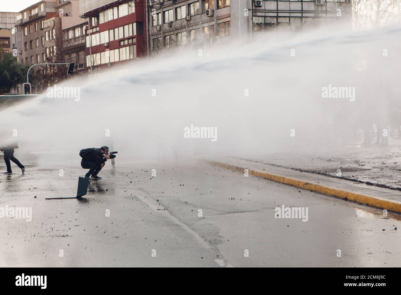 SANTIAGO, CHILE - SEPTEMBER 11, 2020 - A police water cannon disperses protesters against Sebastian Pinera's government. Hundreds of people came to th Stock Photo