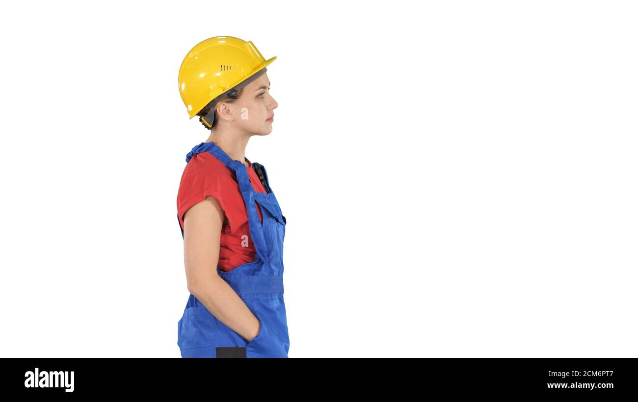 Construction worker lady walking emotionless on white background Stock Photo