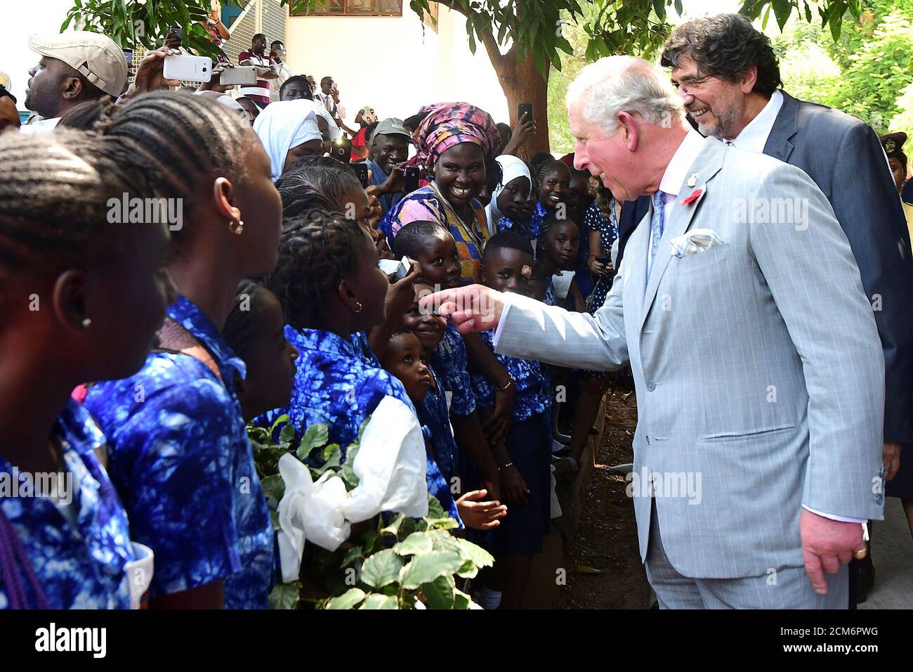 Britain's Prince Charles speaks with children as he arrives to visit a medical research center in Banjul as part of an official visit to Gambia November 1, 2018. Seyllou/Pool via REUTERS Stock Photo