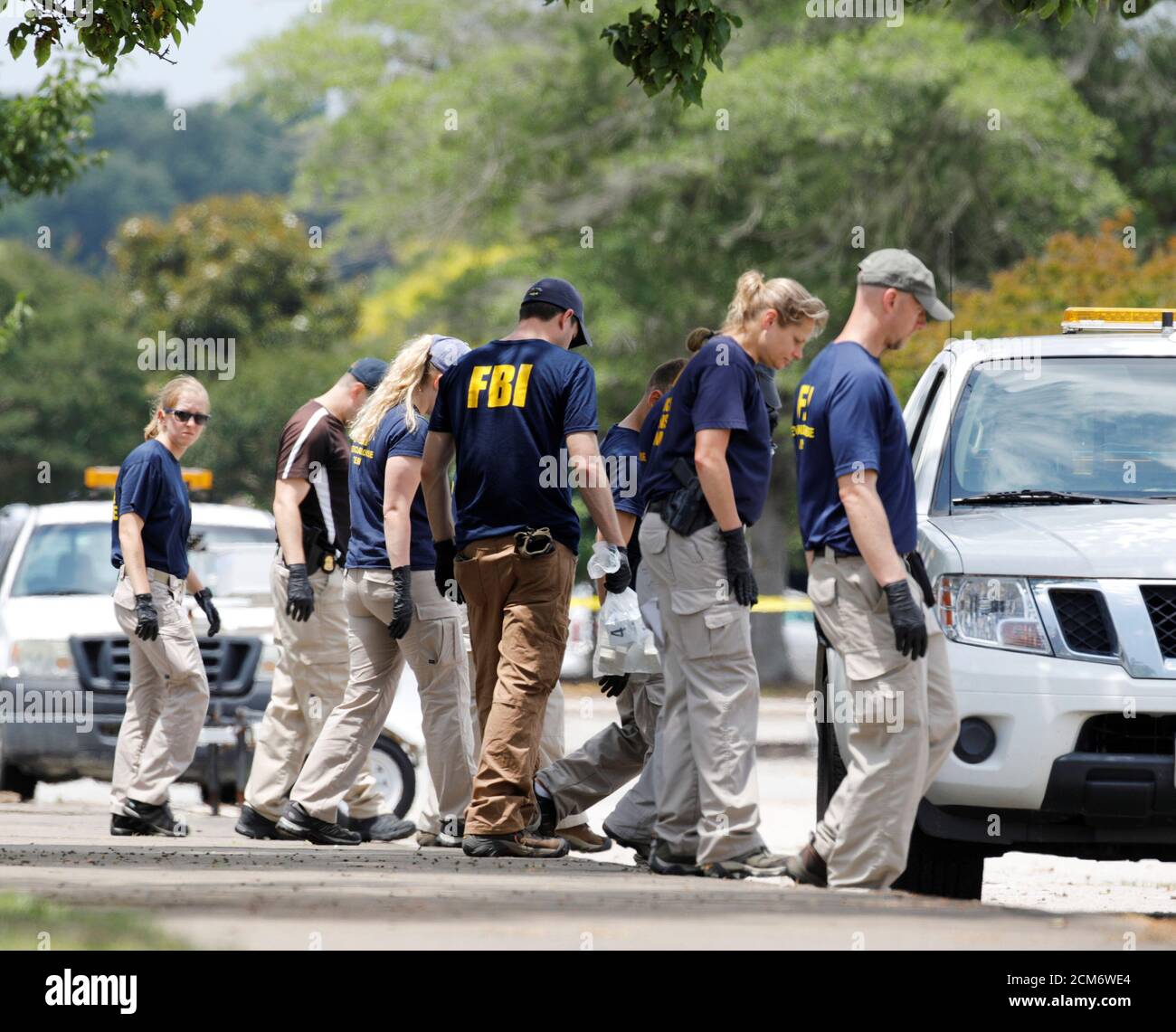 Federal Bureau of Investigation (FBI) Evidence Response Team members search  a parking lot outside a municipal government building where a shooting  incident occurred in Virginia Beach, Virginia, U.S. June 1, 2019.  REUTERS/Jonathan