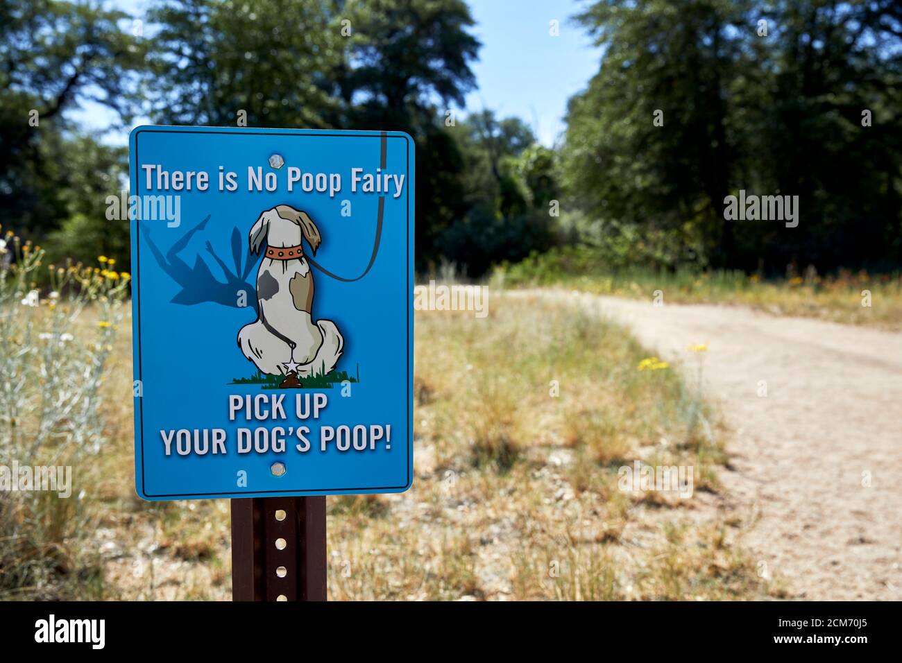 Sign with instructions to pick up your dog's poop at the entrance to a