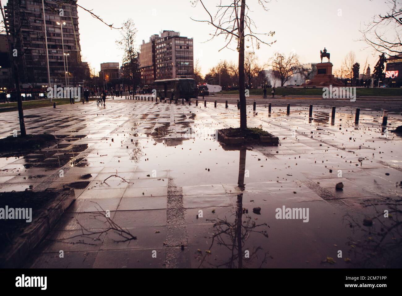 Sidewalks wet from riot police water cannons at dusk. Stock Photo
