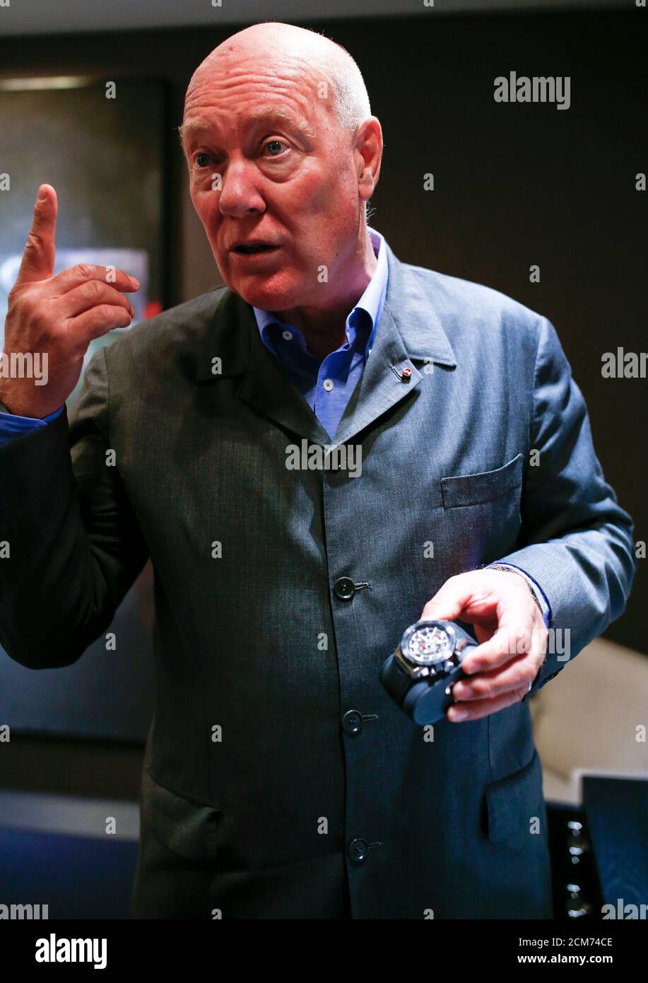 Jean-Claude Biver, head of French luxury goods group LVMH's watch business  and interim CEO of the group's biggest watch brand, TAG Heuer holds a new  Carrera watch before during an interview with