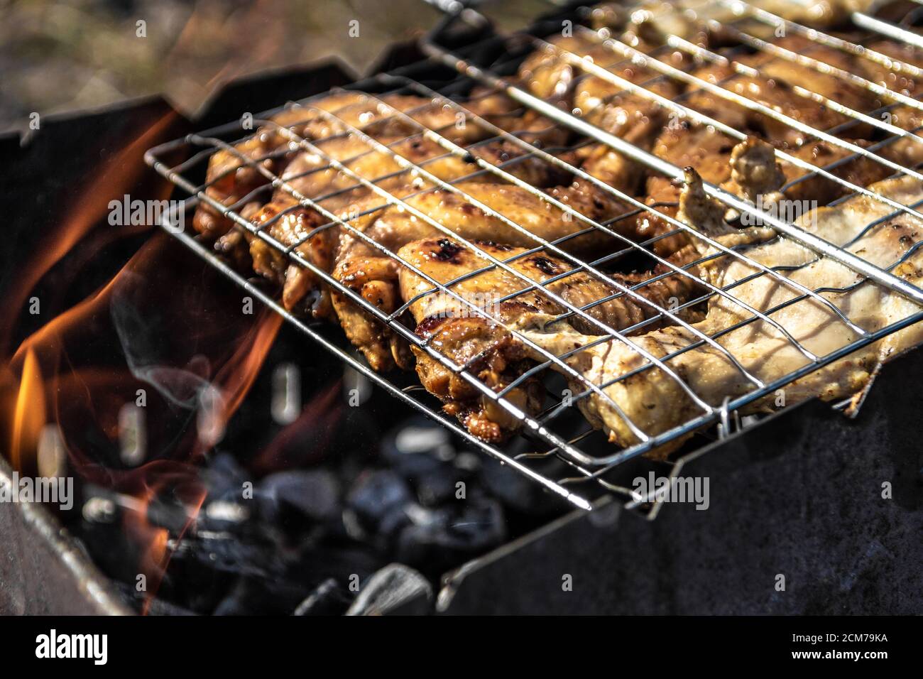Close-up on the process of cooking shashlik, Chicken shashlik roasted over charcoal on grill Stock Photo