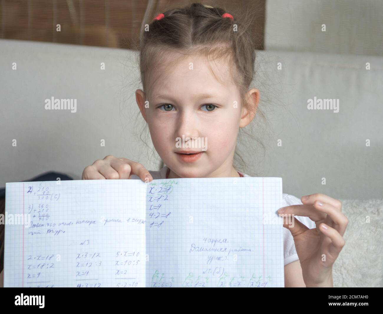 Girl showing homework, Stay at home. Coronovirus. Education and school concept. horizontal Stock Photo
