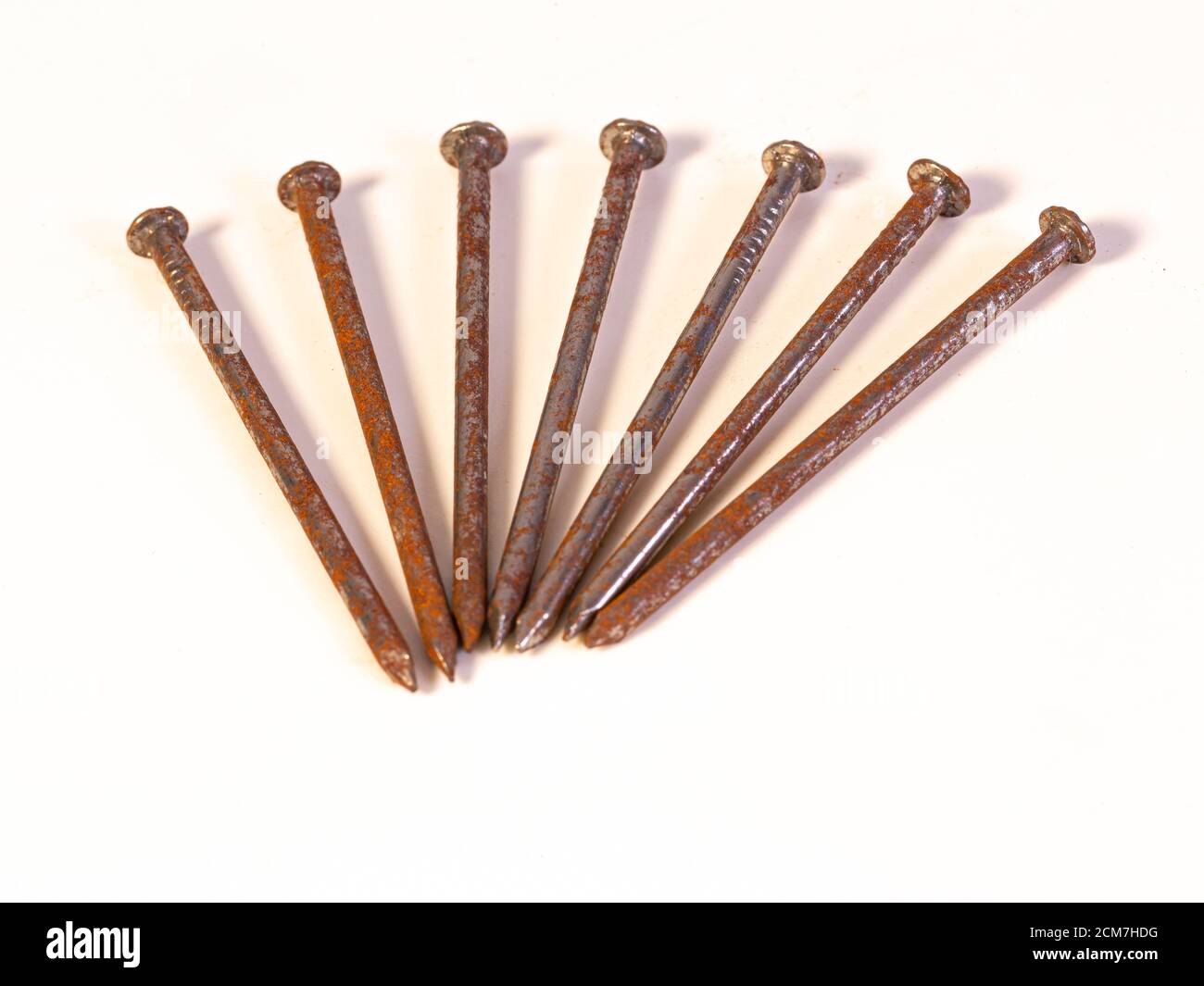 Old and rusty nails lying isolated on white background Stock Photo Alamy