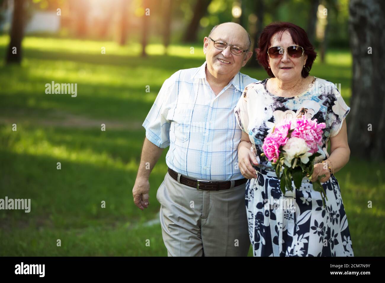 Happy elderly couple. Handsome man and woman senior citizens. Husband and wife of old age for a walk. Stock Photo