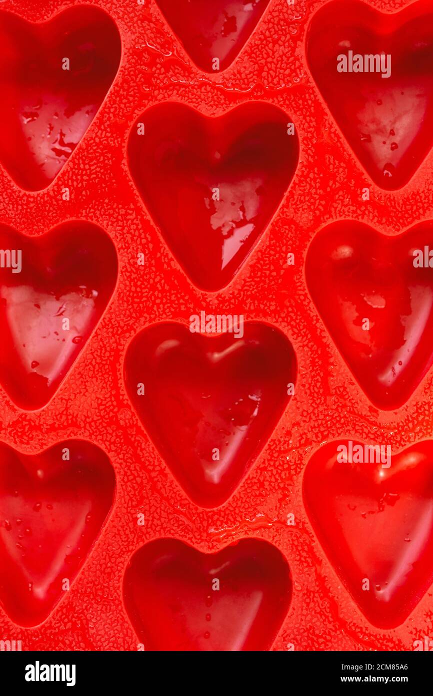 https://c8.alamy.com/comp/2CM85A6/red-hearts-background-silicone-ice-molds-in-the-form-of-hearts-bright-red-hearts-abstract-background-2CM85A6.jpg