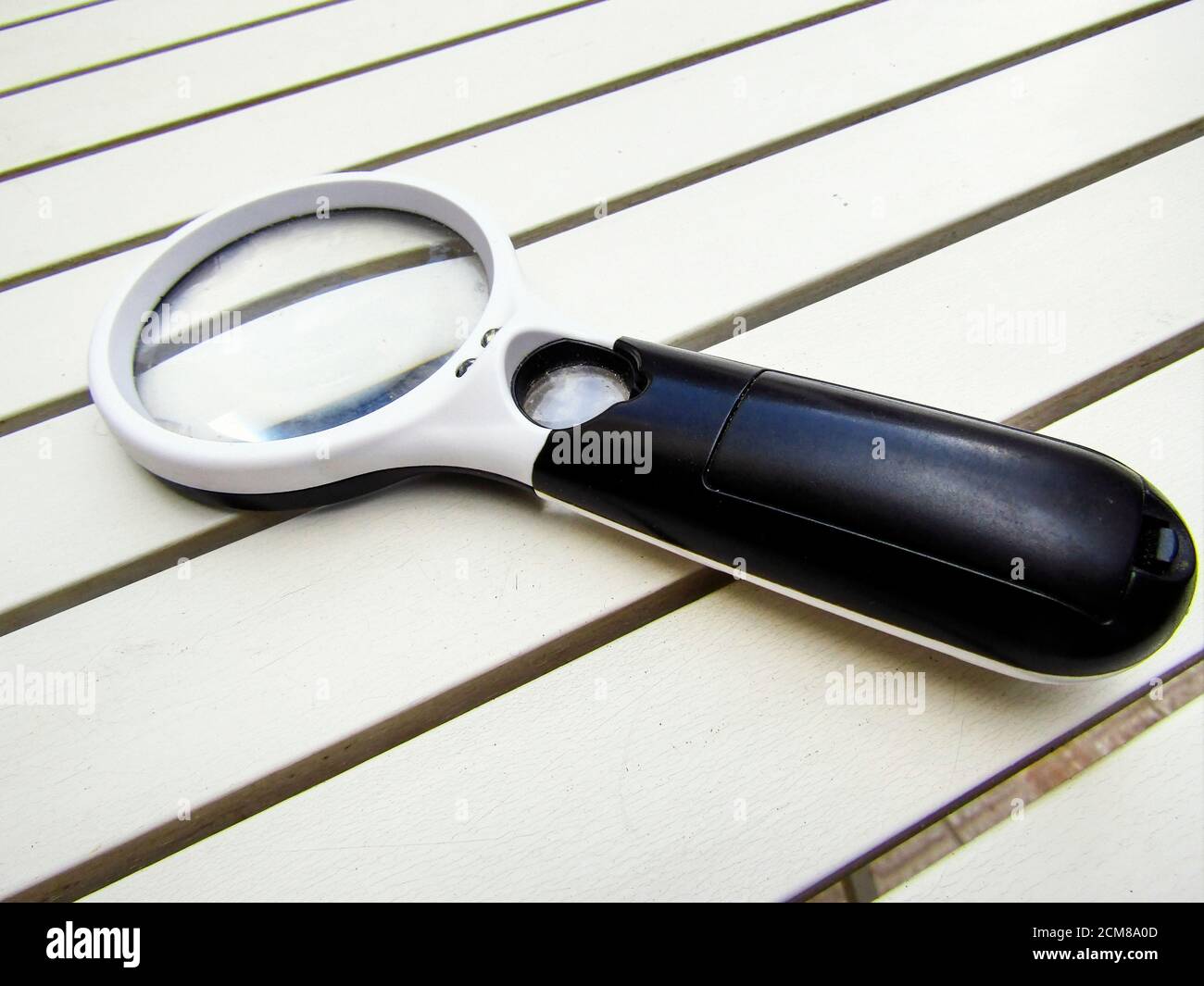 Modern Magnifying Glass on White Table Stock Photo - Alamy