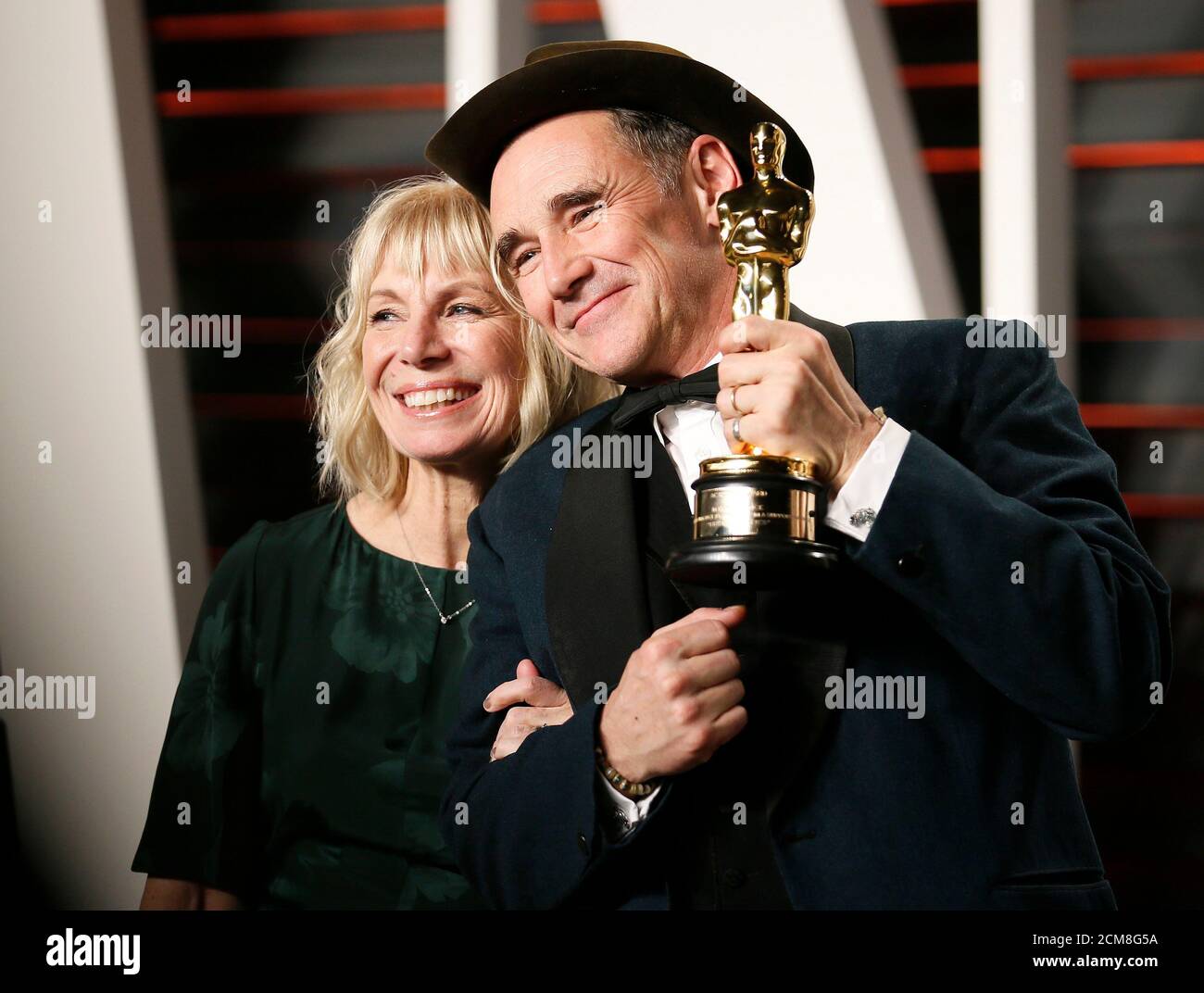 Actor Mark Rylance and his wife Claire van Kampen pose with his Best Supporting Actor award for his role in the film 'Bridge of Spies' during the Vanity Fair Oscar Party in Beverly Hills, California February 29, 2016.  REUTERS/Danny Moloshok Stock Photo