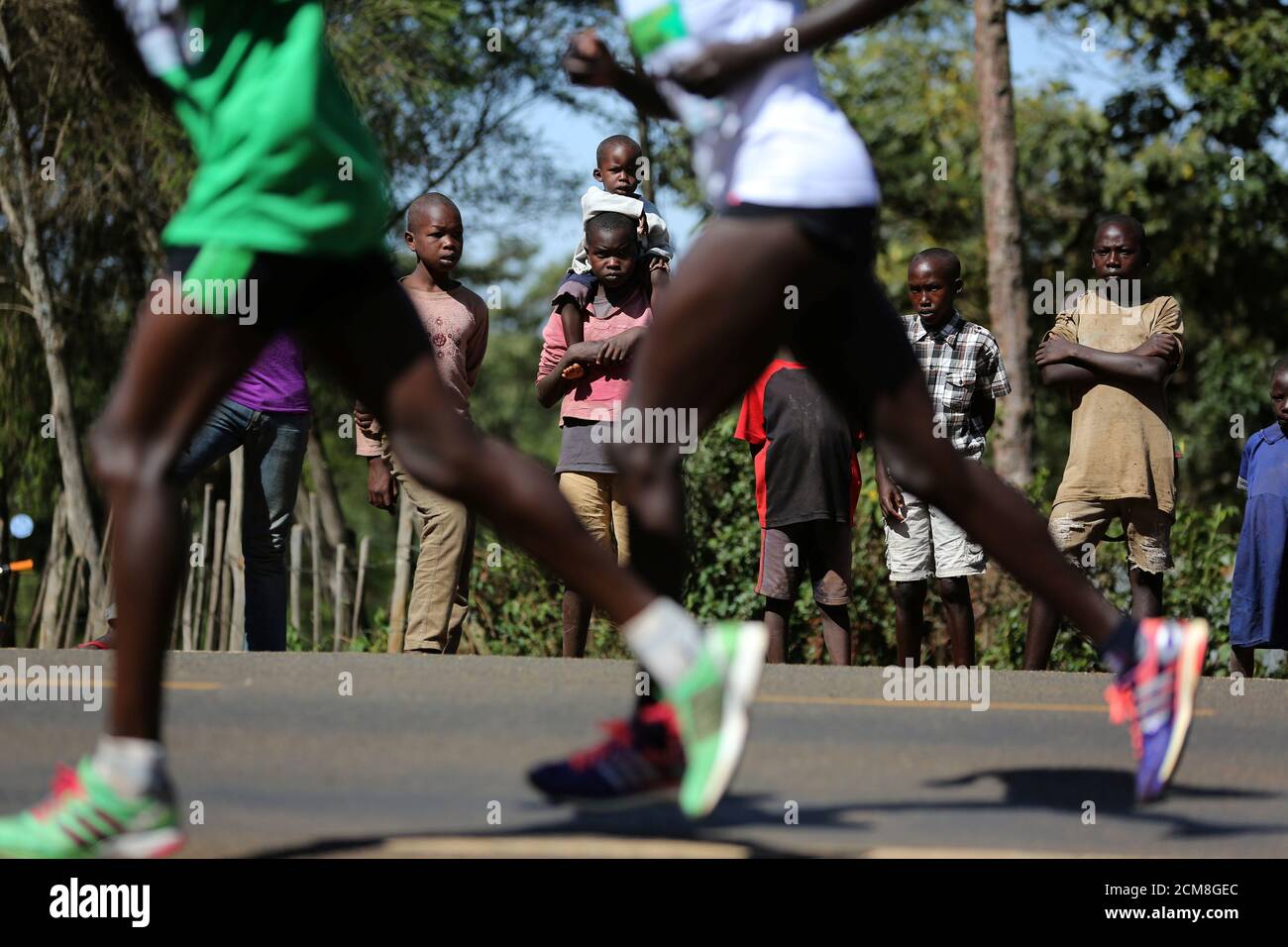 Athletes run on a road during a half marathon near the town of Eldoret in  western Kenya, March 20, 2016. In Kenya's western town of Iten, known as  the "Home of Champions"