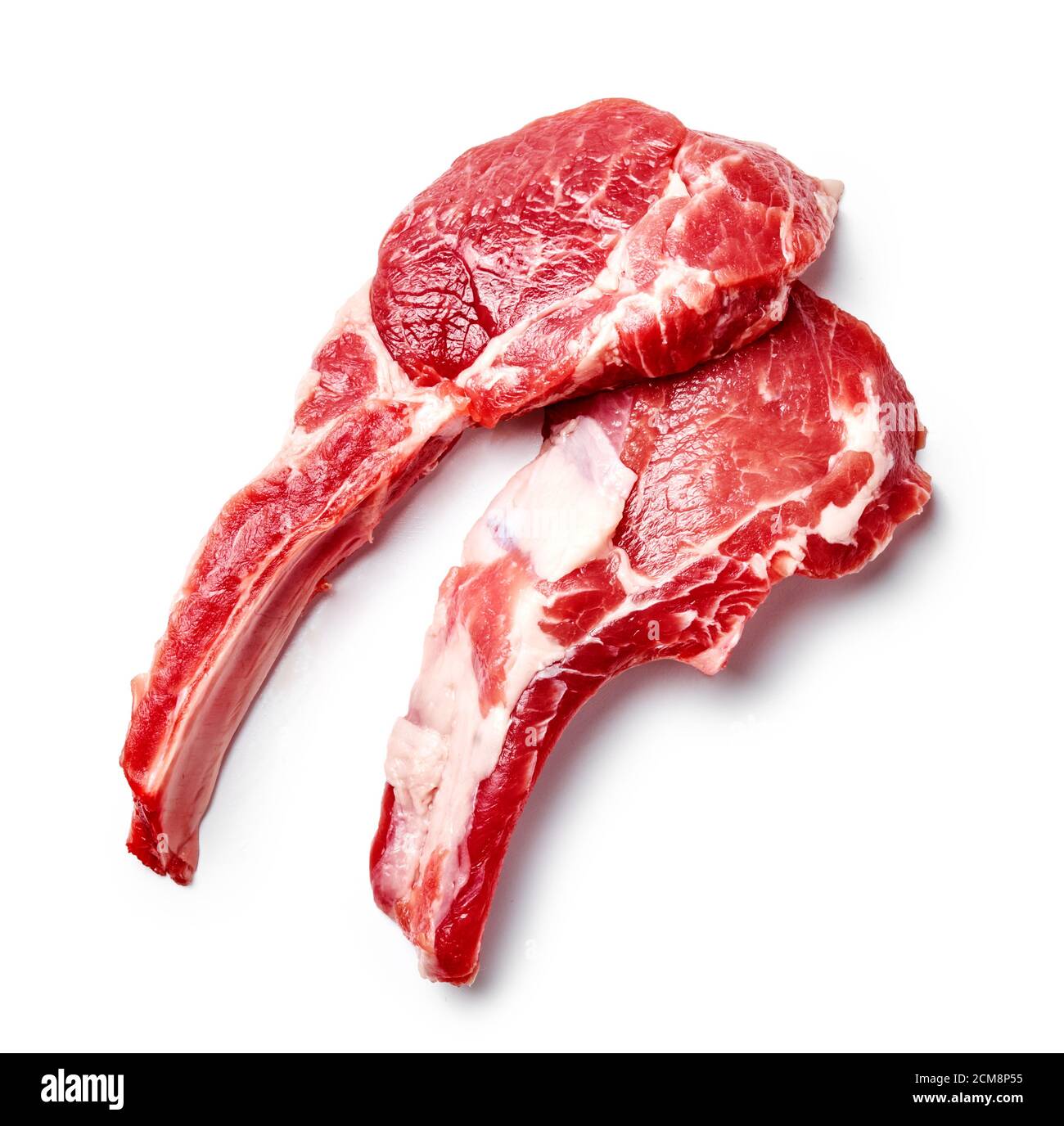Two slices of mutton meat isolated on white. Top view of mutton steaks