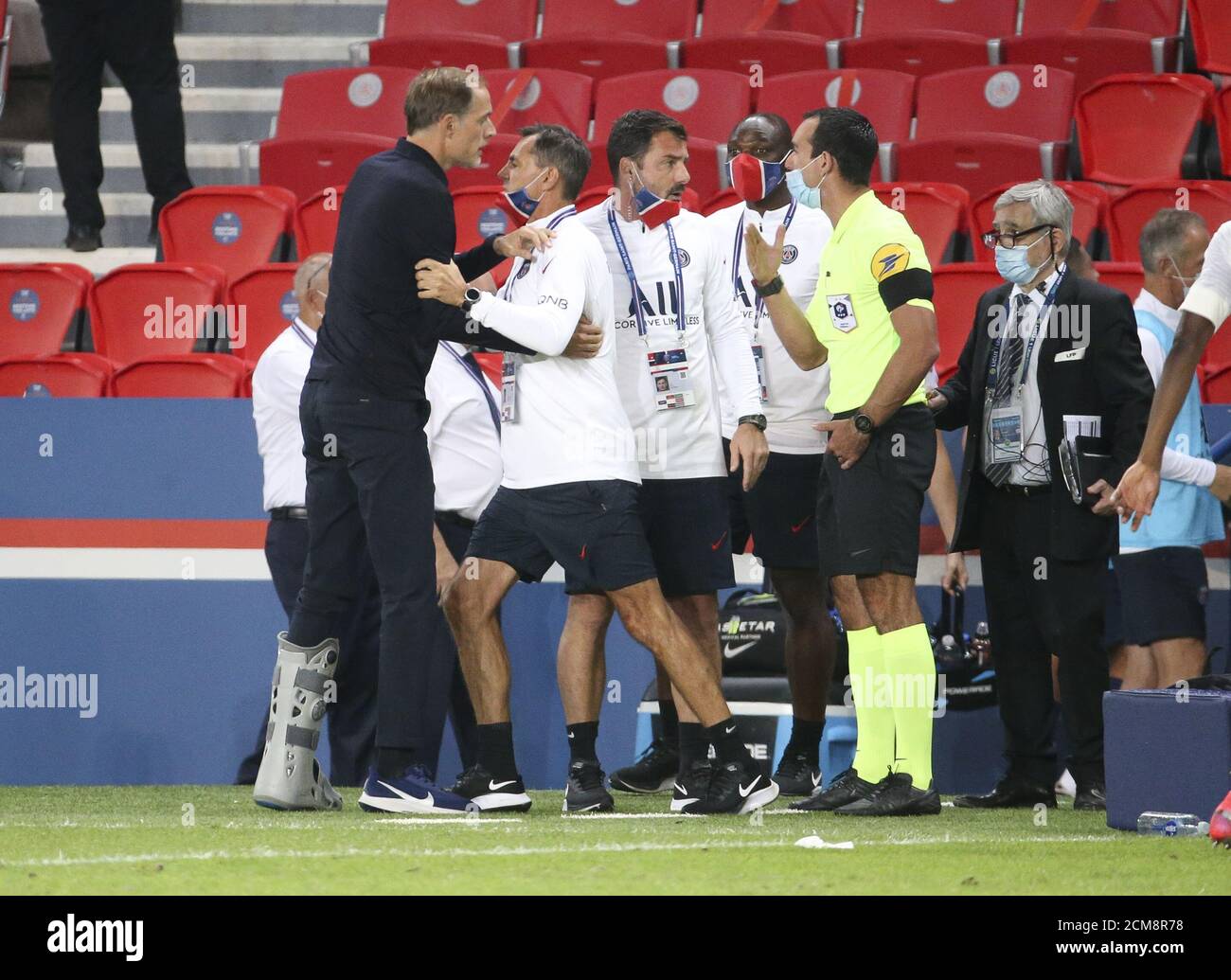 Coach of PSG Thomas Tuchel is restrained by his assistant coaches Arno Michels and Zsolt Low while arguing with the fourth referee Aurelien Petit foll Stock Photo