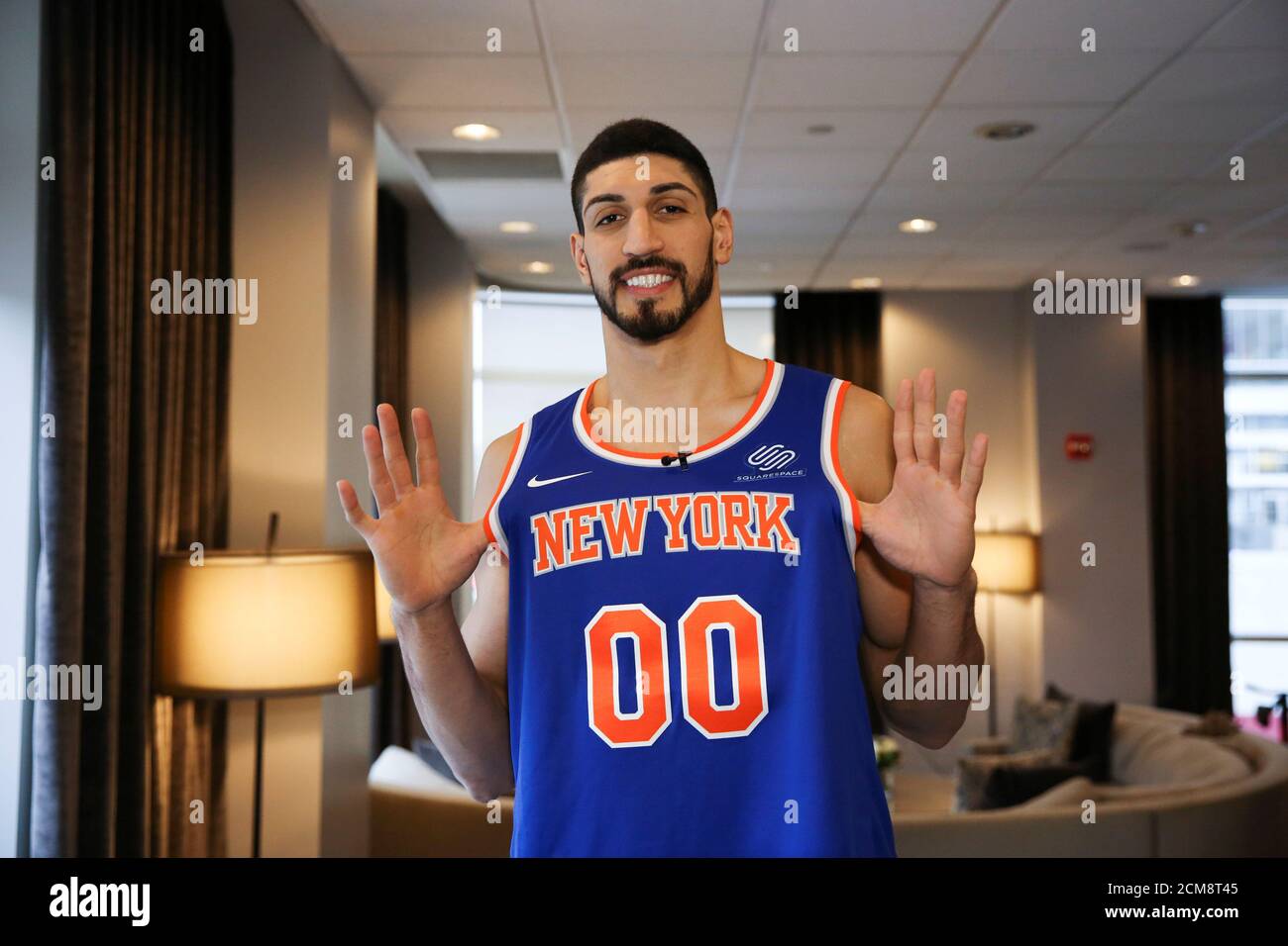 Turkish NBA player Enes Kanter stands for a portrait holding his jersey  during half time after watching his team, the New York Knicks, play the  Washington Wizards at the O2 Arena in