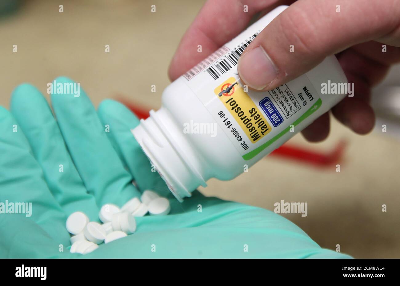 A pharmacist poses with pills of the drug Misoprostol, made by Lupin Pharmaceuticals, in his hand at a pharmacy in Provo, Utah, U.S., June 19, 2019. Picture taken June 19, 2019.  REUTERS/George Frey Stock Photo