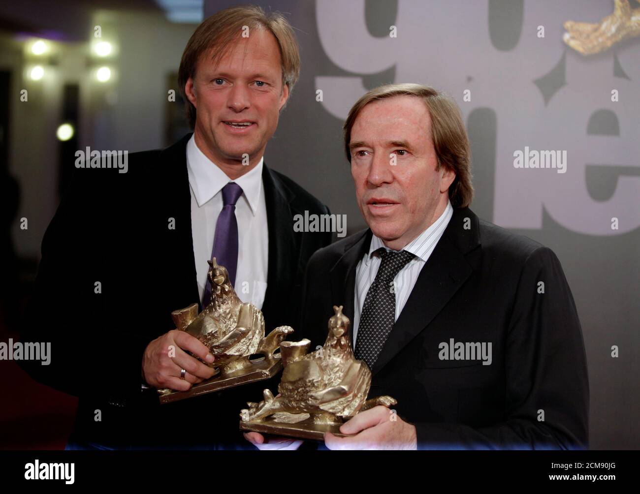 TV sport anchormen Gerhard Delling (L) and former German soccer star  Guenther Netzer arrive as guests in the annual television show 'Menschen  2010' in Munich December 10, 2010. German TV host Thomas