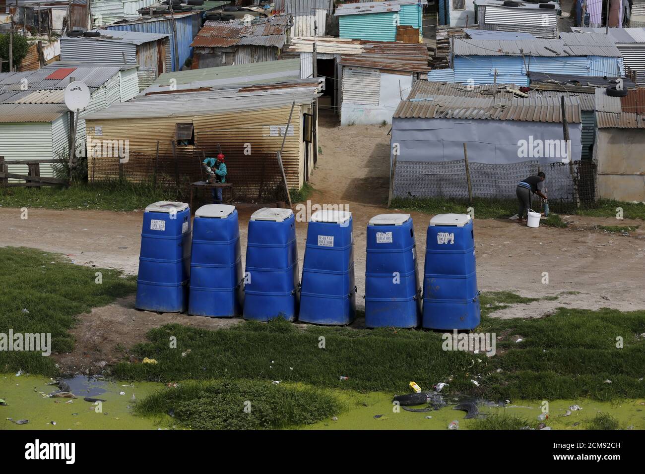 Temporary toilets stand in front of shacks in Khayelitsha township, Cape Town, South Africa, October 14, 2015. Twenty years after South Africa's first democratic elections, the slow pace of delivery of basic services remains a point of tension in some communities. Some 2.4 billion people around the world don't have access to decent sanitation and more than a billion are forced to defecate in the open, risking disease and other dangers, according to the United Nations. The UN says that while there is sufficient fresh water on the planet for everyone, 'bad economics and poor infrastructure' mean Stock Photo