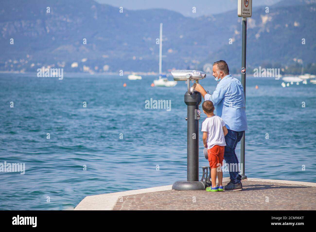 Man looks at binoculars on Garda Lake 2 Stock Photo