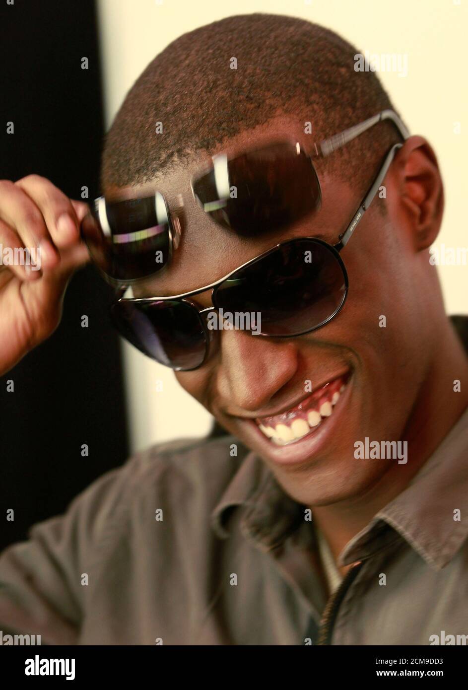 A model tests different sunglasses backstage before the Michael Kors Spring  2011 collection during New York Fashion Week September 15, 2010.  REUTERS/Brendan McDermid (UNITED STATES - Tags: FASHION Stock Photo - Alamy