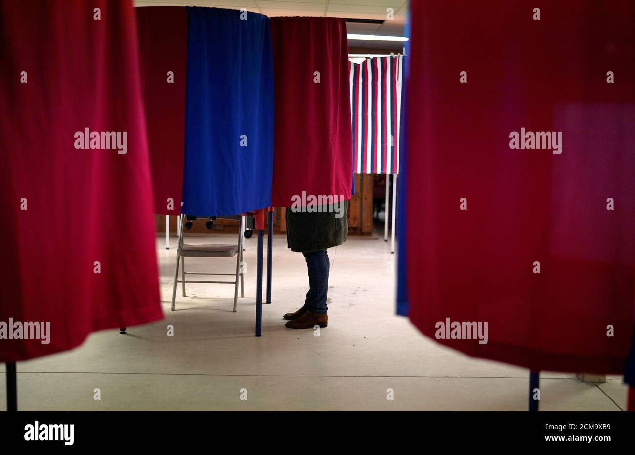 A voter marks her ballot in the state's presidential primary election in Milton, New Hampshire, U.S., February 11, 2020. REUTERS/Rick Wilking Stock Photo