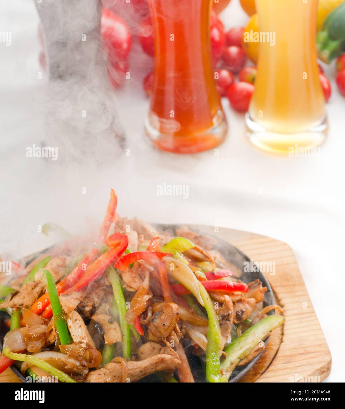 original fajita sizzling hot on iron plate Stock Photo Alamy
