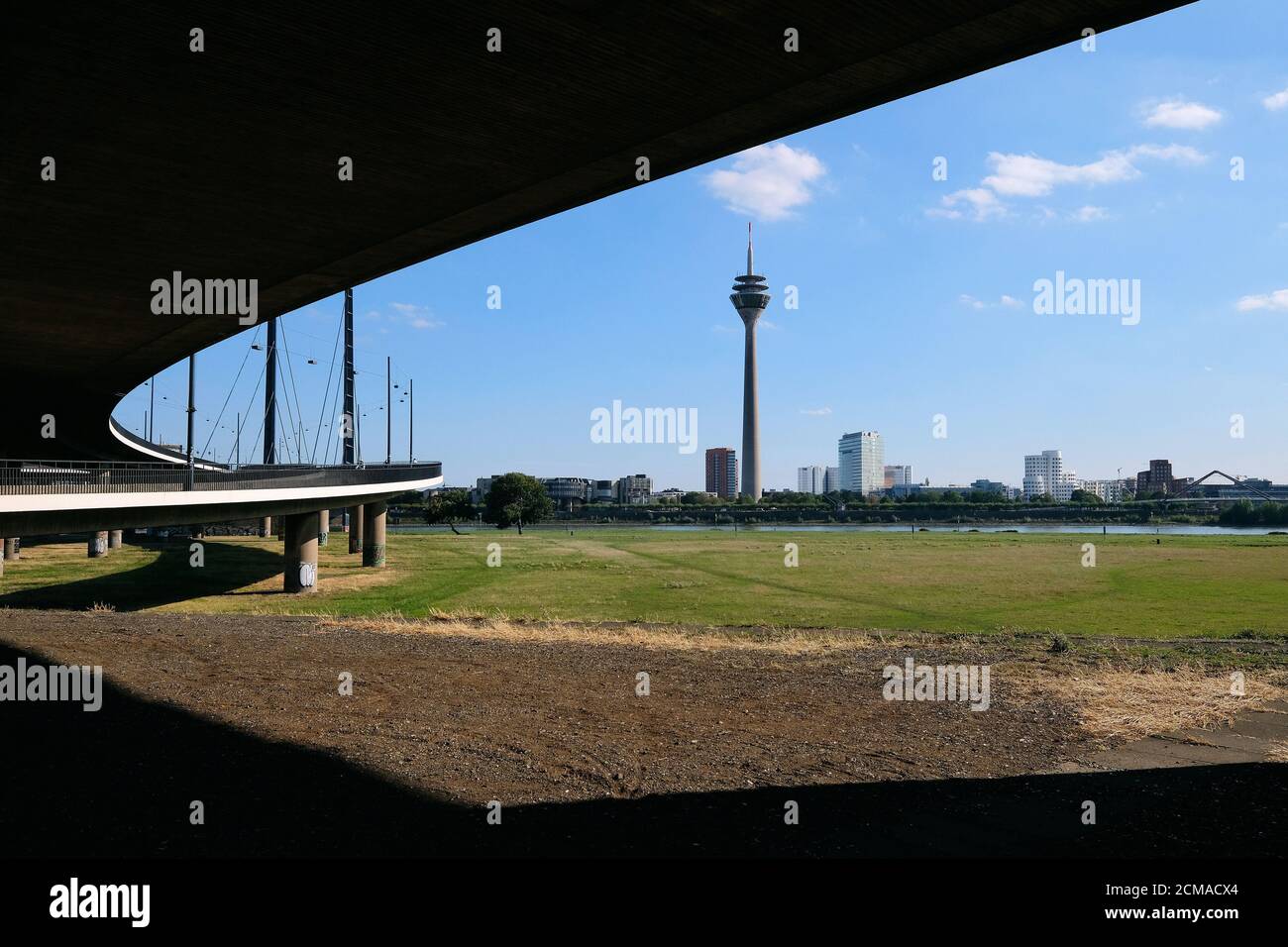 Düsseldorf skyline with television tower, state parliament and city gate as seen from below the Kniebrücke in Oberkassel. Stock Photo