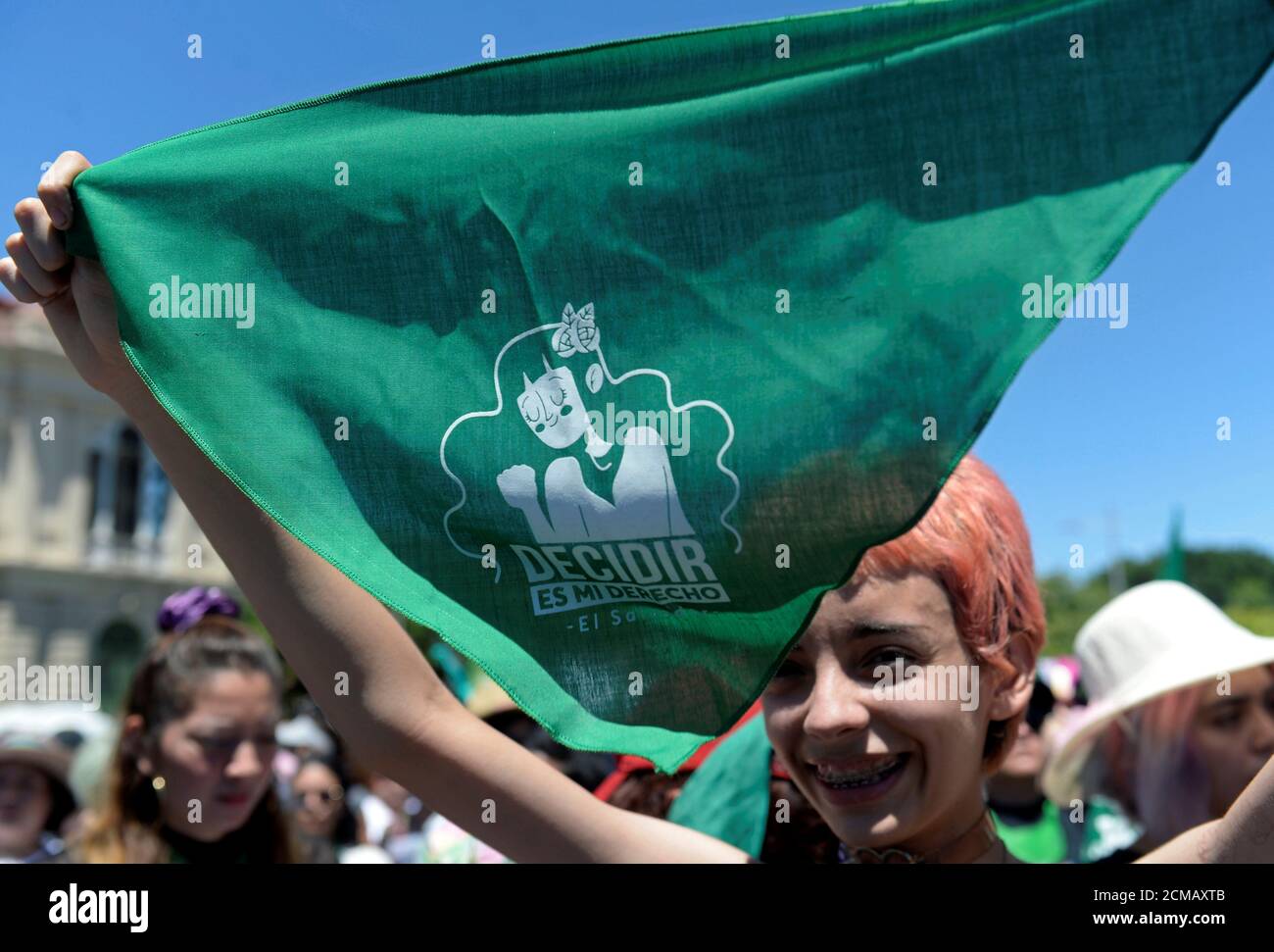 A woman holds up a green handkerchief, symbolizing the abortion rights movement, during a protest to mark International Women's Day in San Salvador, El Salvador March 8, 2020. REUTERS/Jessica Orellana Stock Photo