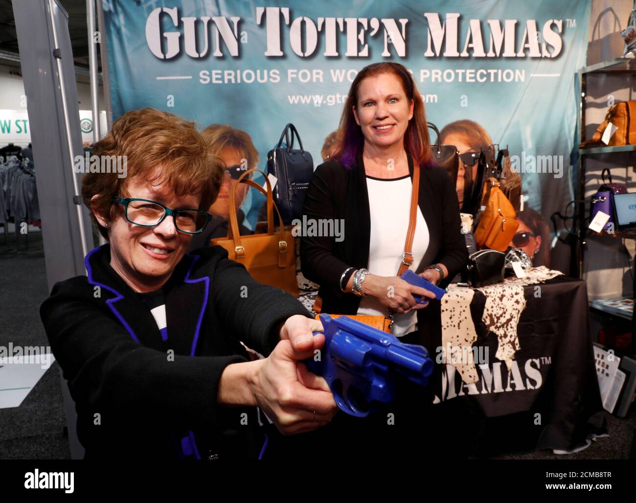 Claudia Chisholm, CEO of Gun Tote'n Mamas, and Carrie Lightfoot, founder of The Well Armed Woman, pose in the Gun Tote'n Mamas booth during the SHOT (Shooting, Hunting, Outdoor Trade) Show in Las Vegas, Nevada, U.S., January 22, 2019. Picture taken January 22, 2019. REUTERS/Steve Marcus Stock Photo