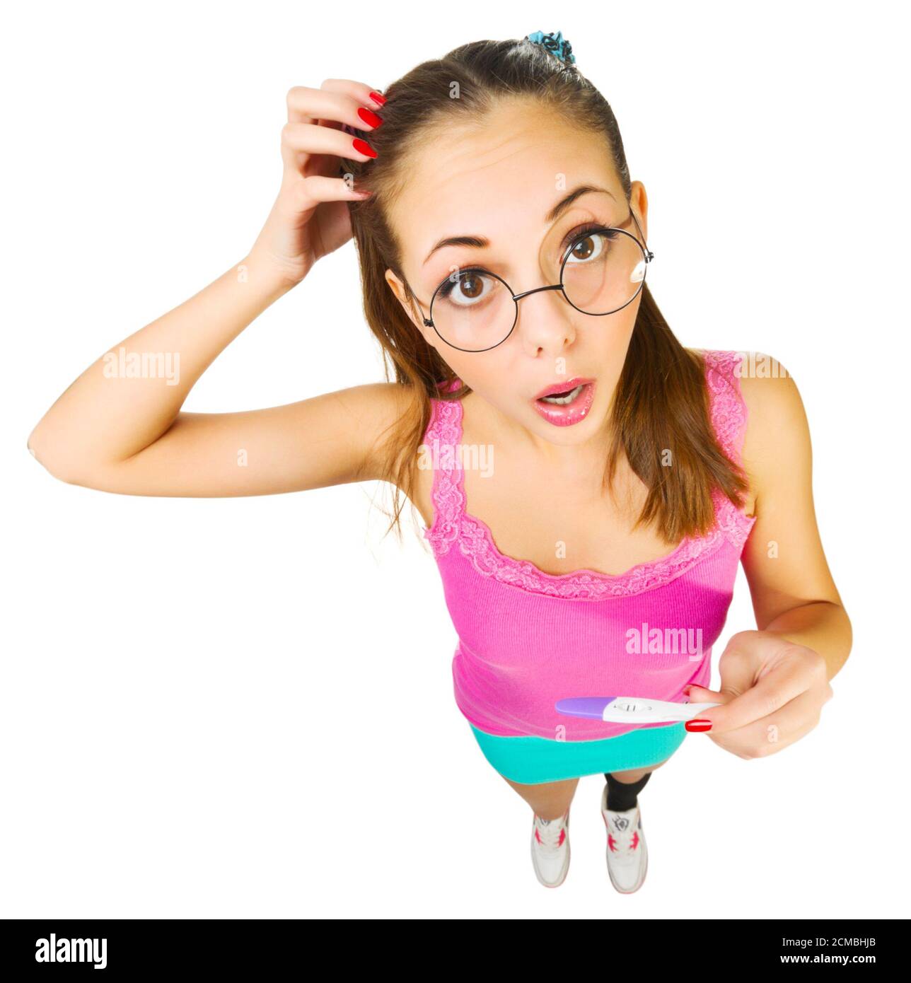 Funny schoolgirl in nerd glasses with positive pregnacy test isolated Stock Photo