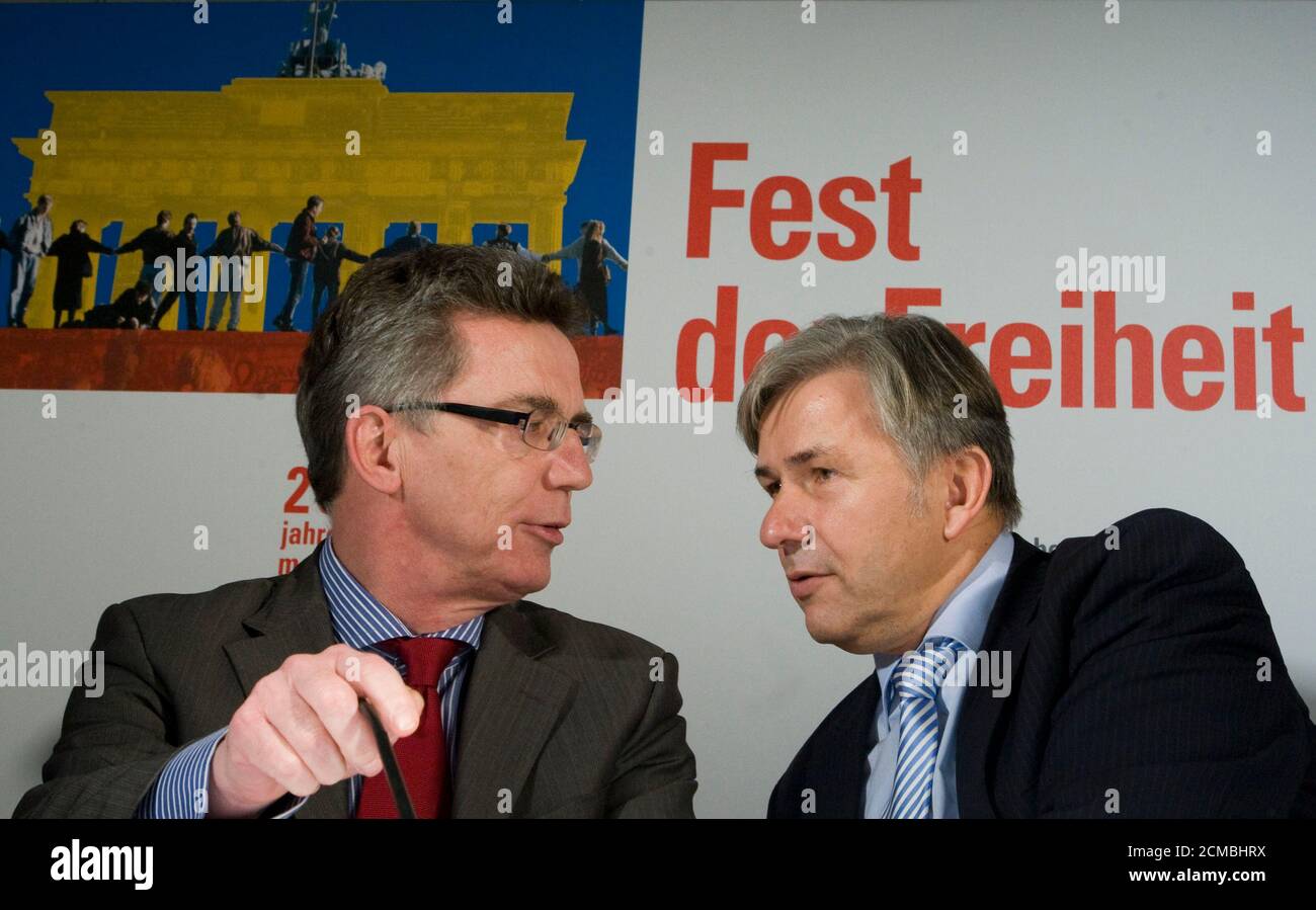 Berlin's Governing Mayor Klaus Wowereit (L) and Chief of the Chancellor's Office Thomas de Maiziere talk during a news conference on the Festival of Freedom, marking the 20th anniversary of the fall of the Berlin Wall in Berlin October 21, 2009. As the highlight of a 5-million euro celebration marking the 20th anniversary of the fall of the Berlin Wall on November 9, a 1.5-km (one-mile) long segment of the Wall will stand for two days along its original route in front of the Brandenburg Gate to the Potsdamer Platz. The row of 1,000 20-kg dominos standing 1.5 metres apart -- painted in bright c Stock Photo