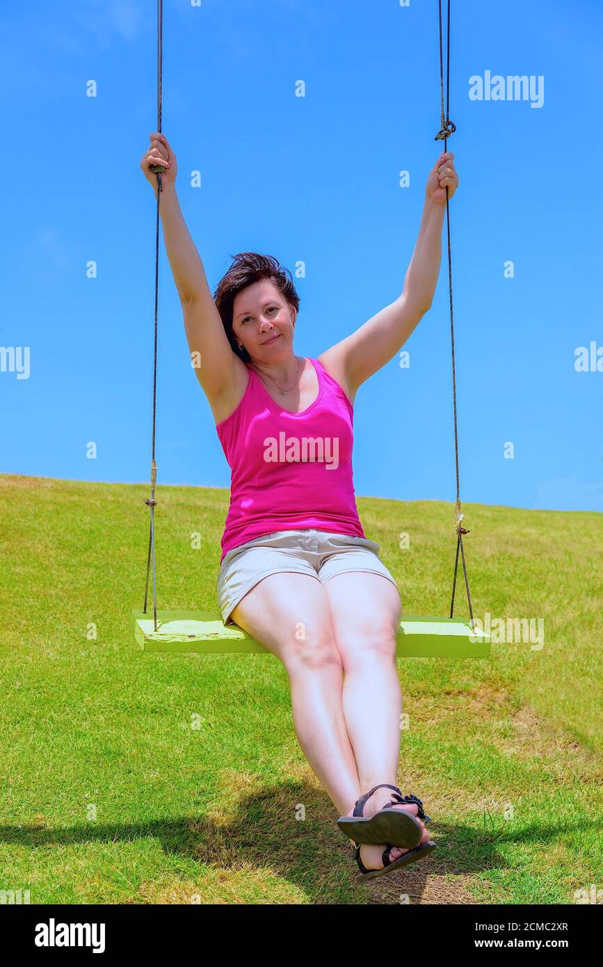 Woman on a swing Stock Photo - Alamy