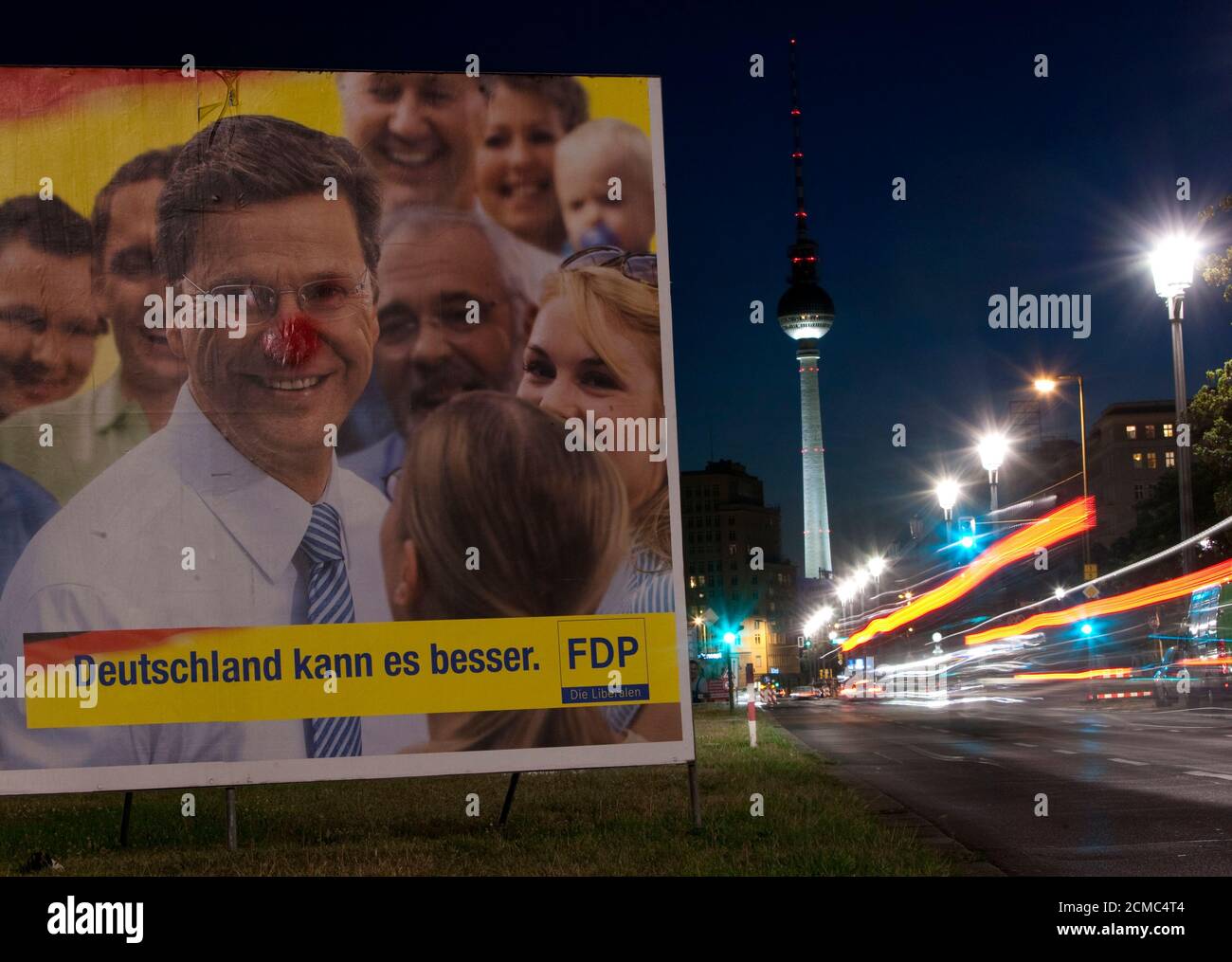 An election poster of the liberal FDP party shows its party leader Guido Westerwelle near the Fernsehturm television tower in Berlin  August 31, 2009.   REUTERS/Thomas Peter  (GERMANY POLITICS ELECTIONS) Stock Photo