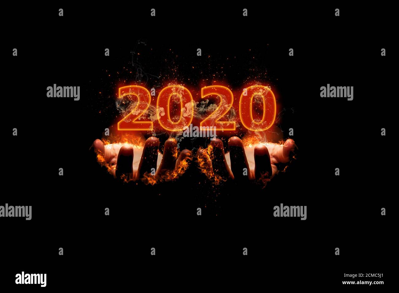 New Year concept 2020 design with fire on the fire was burning hands. Stock Photo