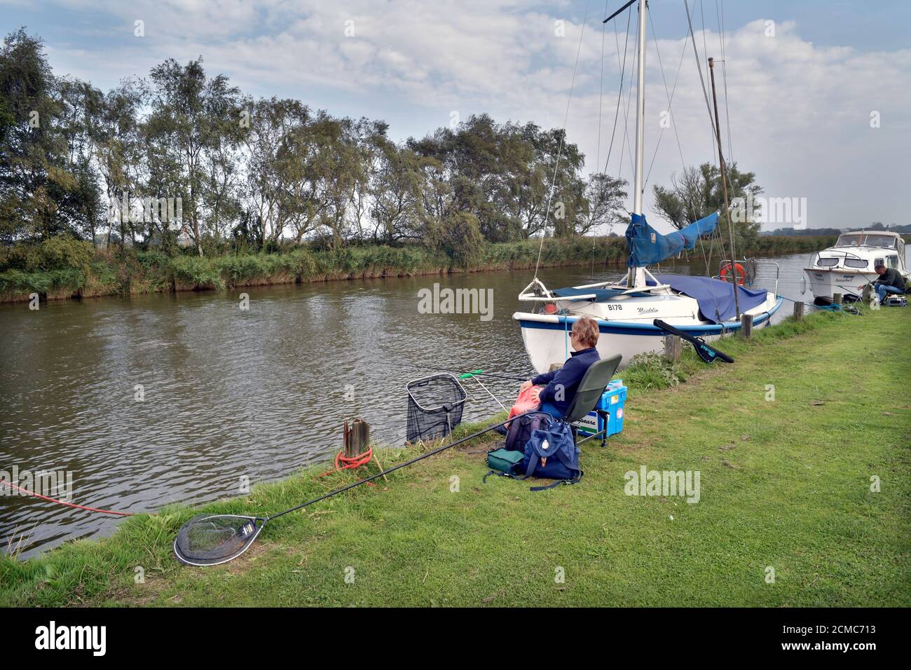 fishing beside river thurne martham norfolk england Stock Photo