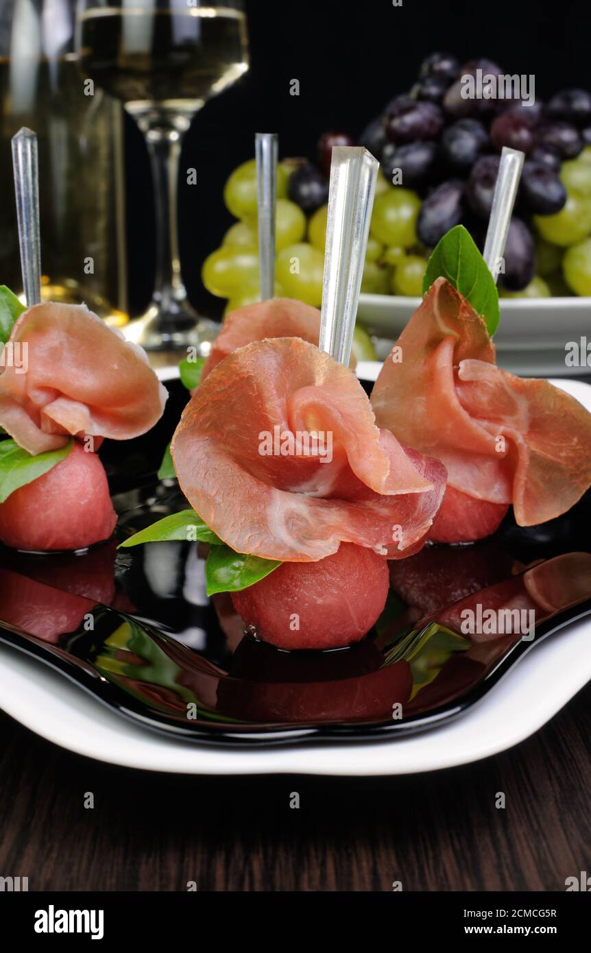 Canape of watermelon balls with gammon Stock Photo