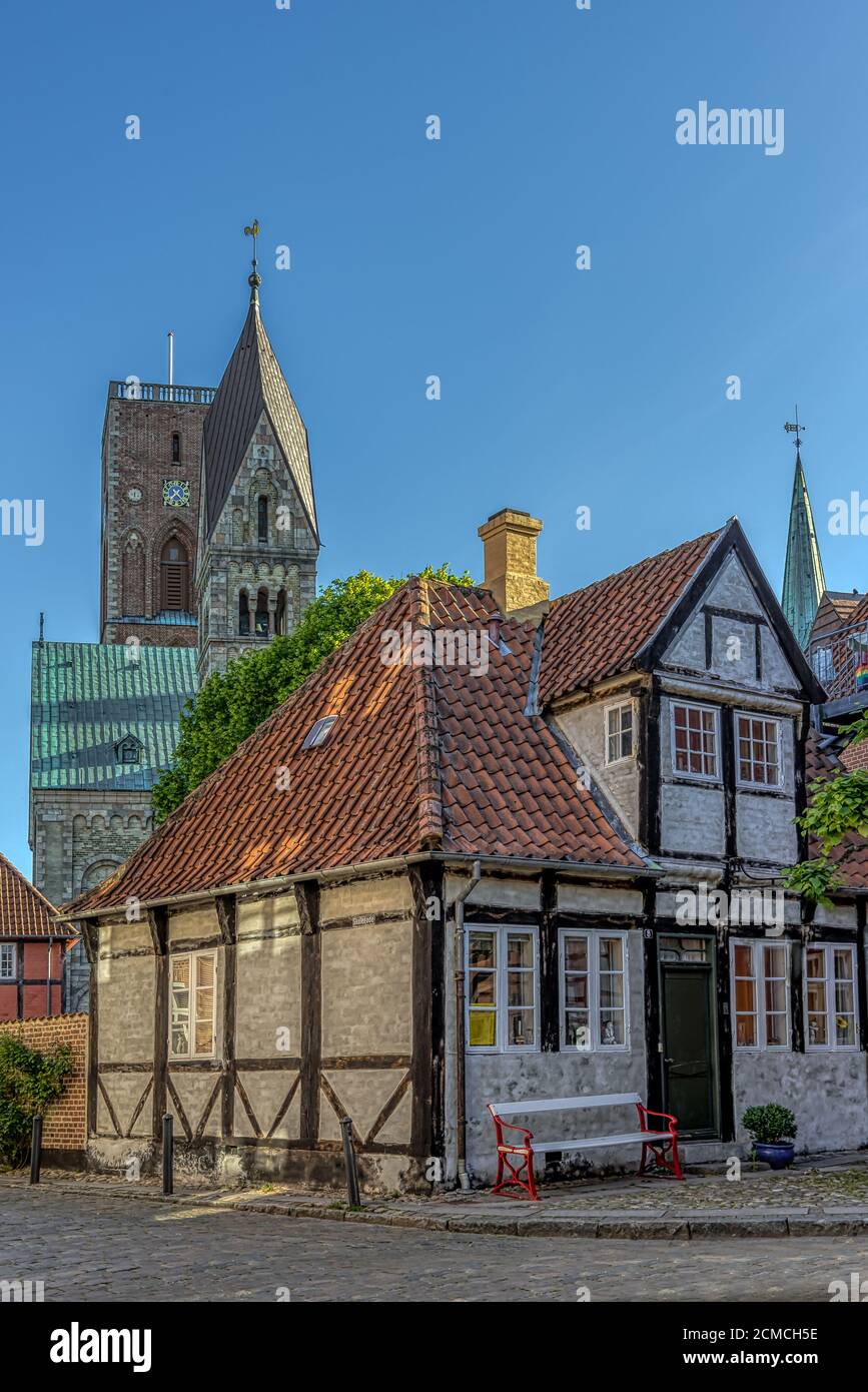 A half-timbered house and the Ribe cathedral with its two towers in the background, Ribe, Denmark, June 1, 2020 Stock Photo