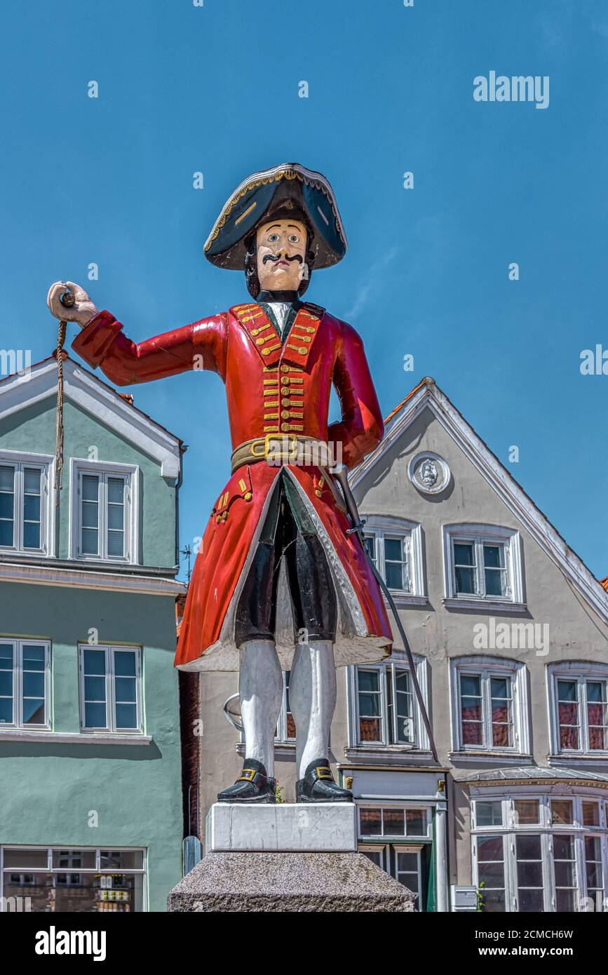 A soldier-like whipping post-man holding a whip in his left hand, standing in the square of Tønder, Denmark, June 1, 2020 Stock Photo