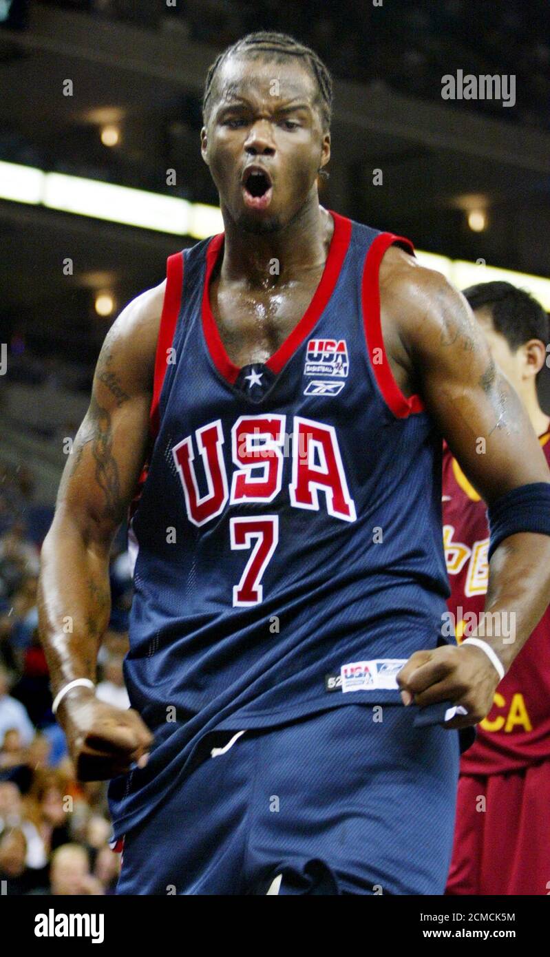 USA Basketball team's center Jermaine O'Neal reacts after slamming the ball  in the first half against the China World Basketball during an exhibition  game on August 22, 2002 in Oakland, California. Both