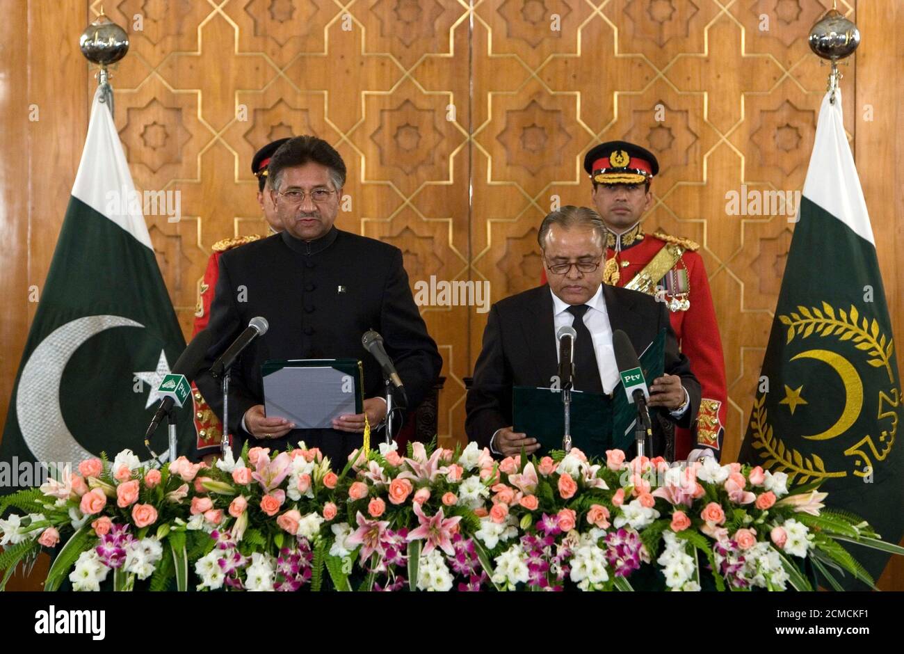 Pakistan's President Pervez Musharraf (L) is sworn in by Chief Justice Abdul Hameed Dogar at the President House in Islamabad November 29, 2007. Musharraf was sworn in for a second term on Thursday, but this as a civilian leader a day after quitting as army chief and fulfilling a promise many Pakistanis doubted he would keep. REUTERS/Adrees Latif    (PAKISTAN) Stock Photo