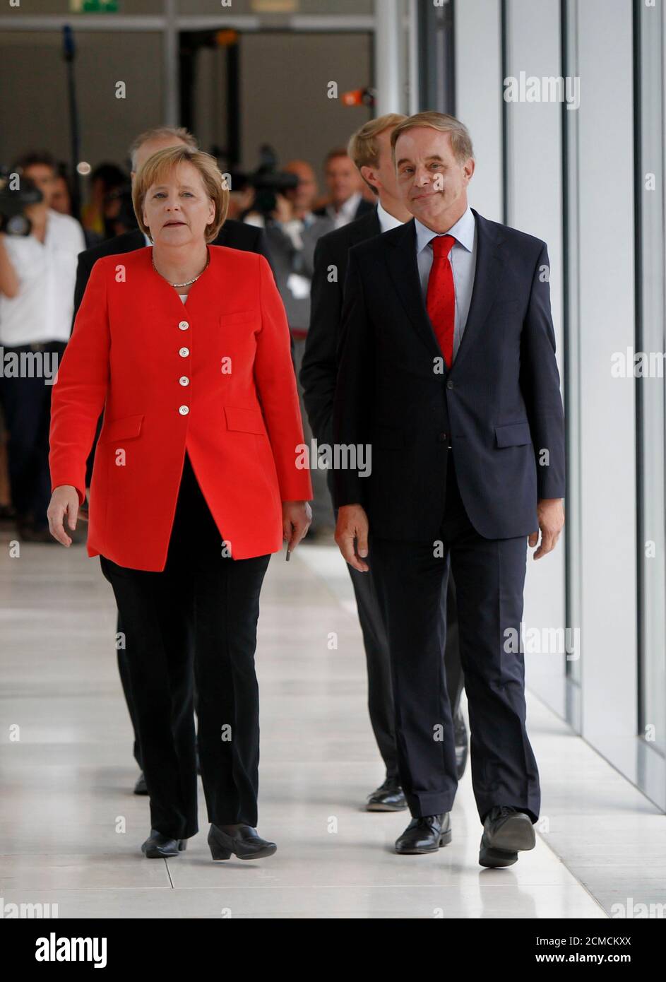 German Chancellor and head of the Christian Democratic Union (CDU) Angela Merkel (L) arrives with Joerg van Essen of the liberal Free Democratic Party (FDP) to join a FDP parliamentary group meeting in Berlin, July 6, 2010. REUTERS/Thomas Peter  (GERMANY - Tags: POLITICS) Stock Photo