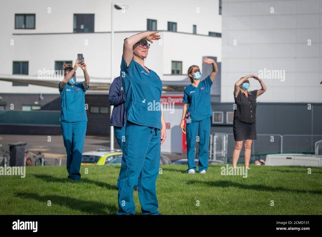 Staff at the Royal Infirmary of Edinburgh watch as the 'Thank You NHS' Spitfire passes overhead during a tour around Scottish hospitals to raise money for NHS Charities Together. Stock Photo