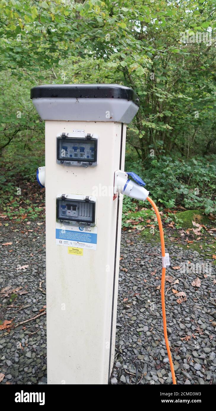 Electric hookup post at campsite Stock Photo - Alamy
