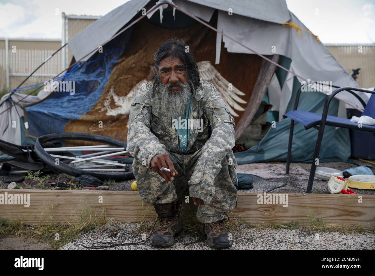Daniel J. Wabsey, a 58-year-old war veteran, sits outside his tent at Camp Hope in Las Cruces, New Mexico October 6, 2015. 'I've been traveling for 35 or 38 years. Getting inside would take a while to get used to. I just want to be able to eat, sleep and be safe. We all get along and understand in Camp Hope. We've all been there. With common sense you can survive out here,' Wabsey said. Camp Hope describe themselves as an 'alternative transitional living project for the homeless'. Around 50 people live at the camp. REUTERS/Shannon Stapleton PICTURE 6 OF 35 - SEARCH 'STAPLETON TENTS' FOR ALL IM Stock Photo