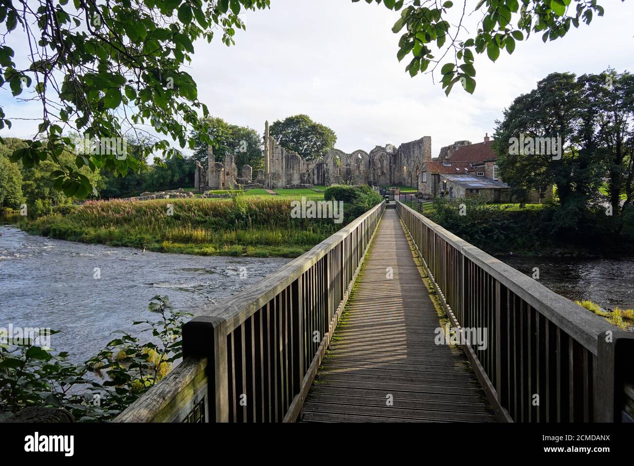 Wooden footbridge over River Wear at Finchale Priory Stock Photo