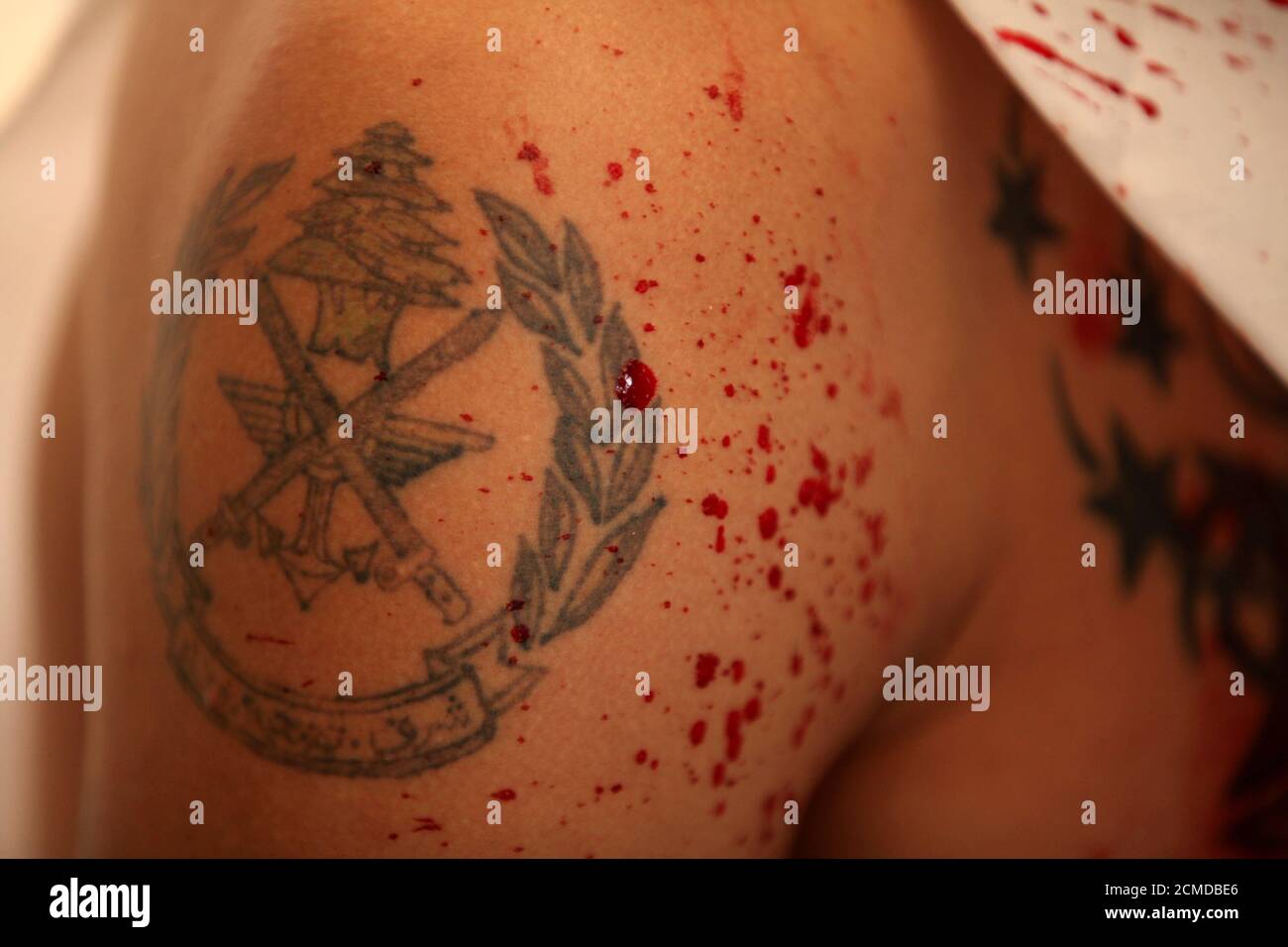 A Shi Ite Muslim Man S Tattoo Of A Lebanese Army Logo Is Pictured On His Arm As He Rests After Gashing His Forehead With A Razor During A Religious Procession To Mark Ashura A Shi Ite Muslim Man S Tattoo Of A Lebanese Army Logo Is Pictured On His Arm As He Rests After Gashing His Forehead With A Razor During A Religious Procession To Mark Ashura
