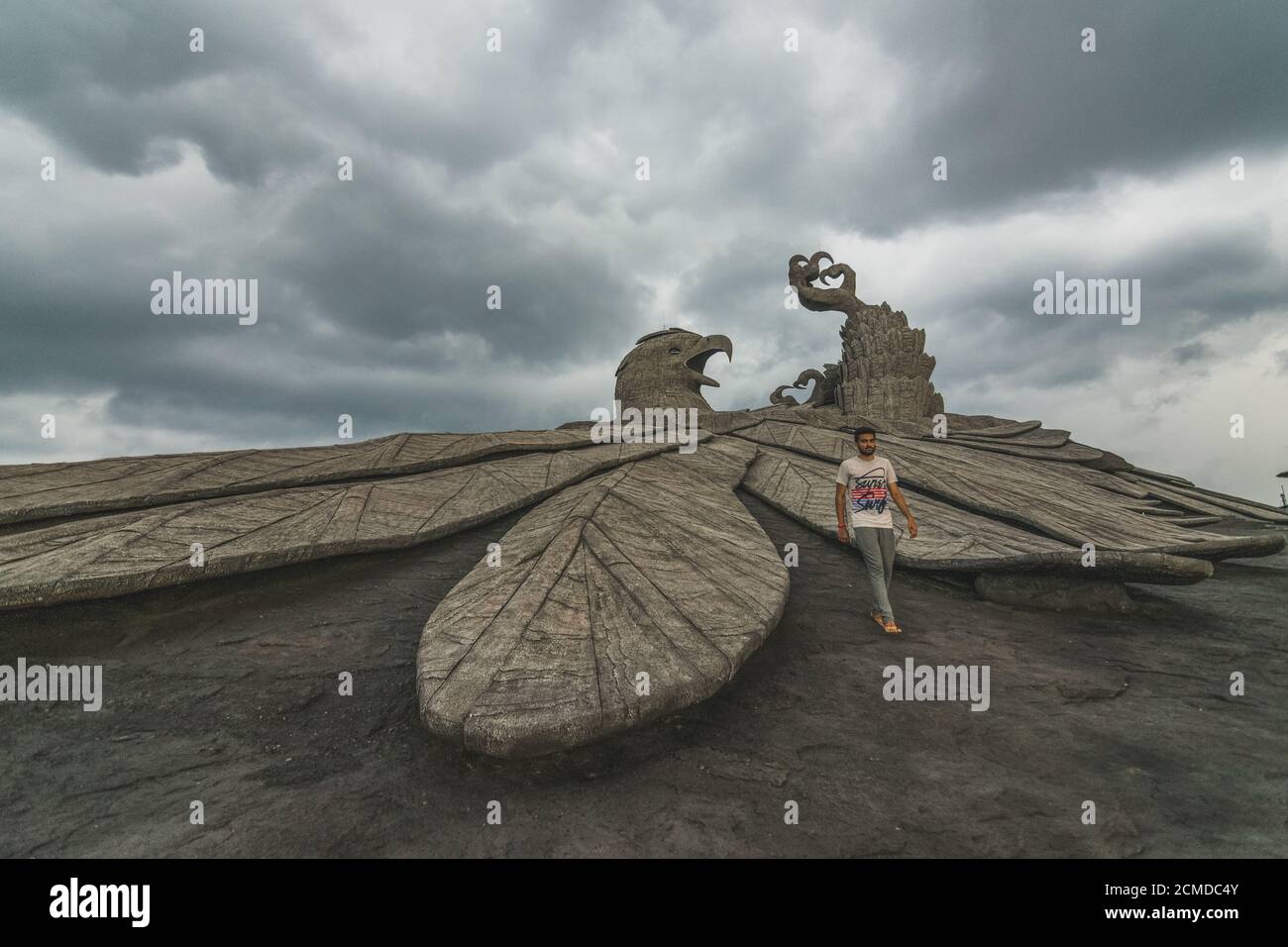 KOLLAM, INDIA - Sep 11, 2019: An Indian Male walking next to the World's Largest Eagle Statue named Jatayu located in Kollam, Kerala Stock Photo