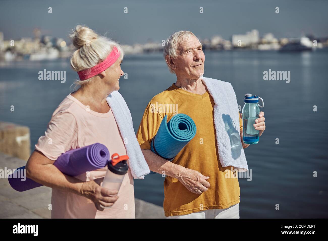 Two pensioners standing on the river bank Stock Photo