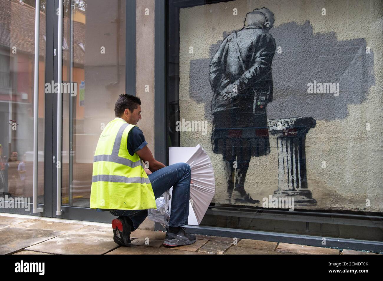 Art Buff, a painting by street artist Banksy, is re-installed on Folkestone's Old High Street, as Creative Folkestone announces a new art project called The Plinth – placing 10 vacant plinths in various locations around the seaside town and inviting residents and visitors to use them to display their artistic talents. Stock Photo