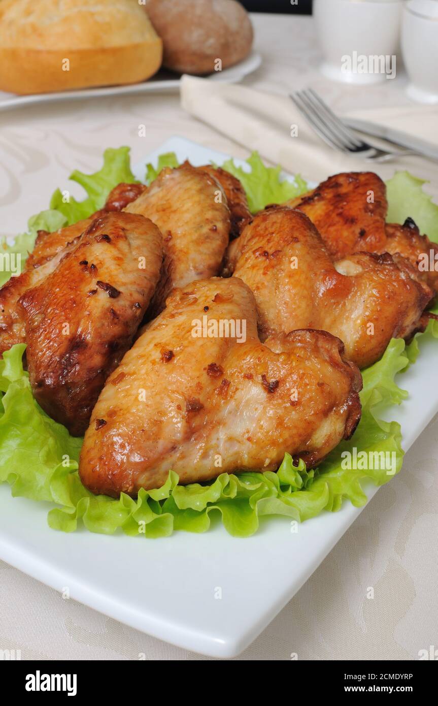 Baked chicken wings with garlic Stock Photo - Alamy