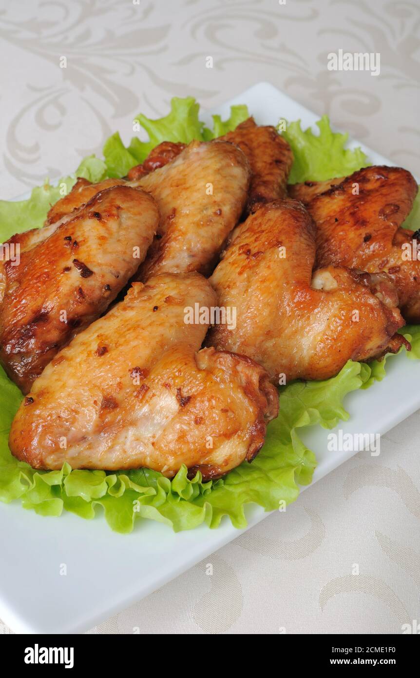 Baked chicken wings with garlic Stock Photo - Alamy